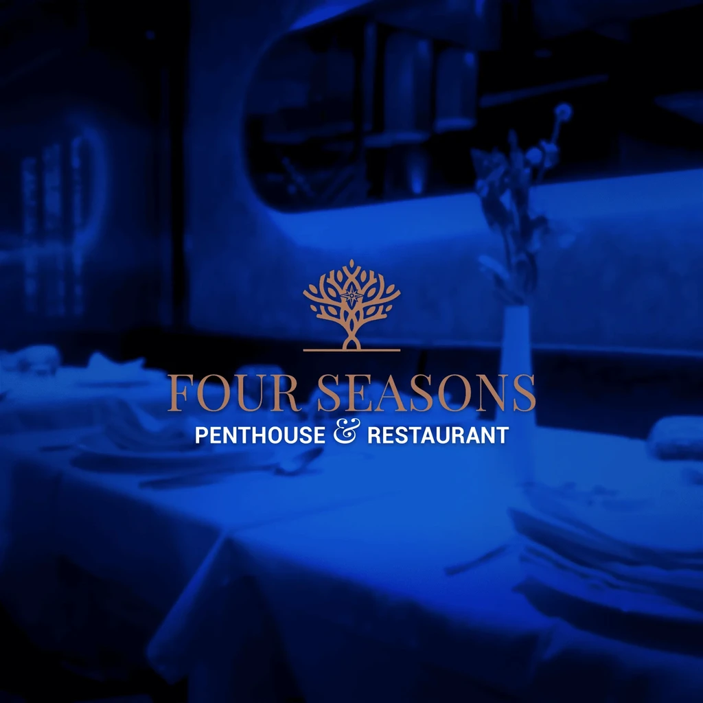 Four Seasons Penthouse and Restaurant logo on a blue table setting