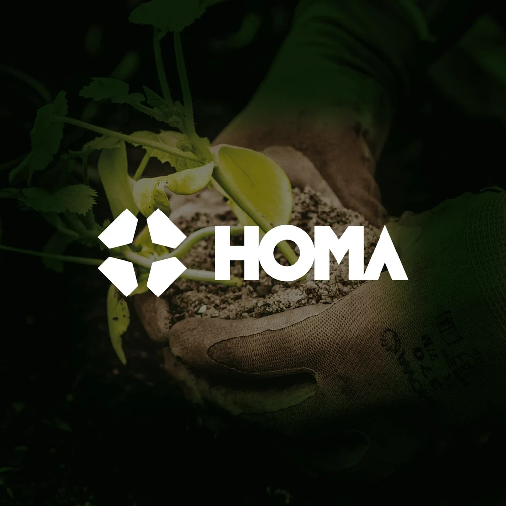 Homa logo over a photo of hands holding a seedling